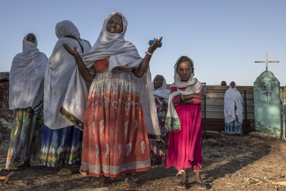 A Tigrayan woman who fled the conflict in Ethiopia's Tigray region prays after Sunday Mass ends at a nearby church, in Umm Rakouba refugee camp in Qadarif, eastern Sudan, Nov. 29, 2020. (AP Photo/Nariman El-Mofty)