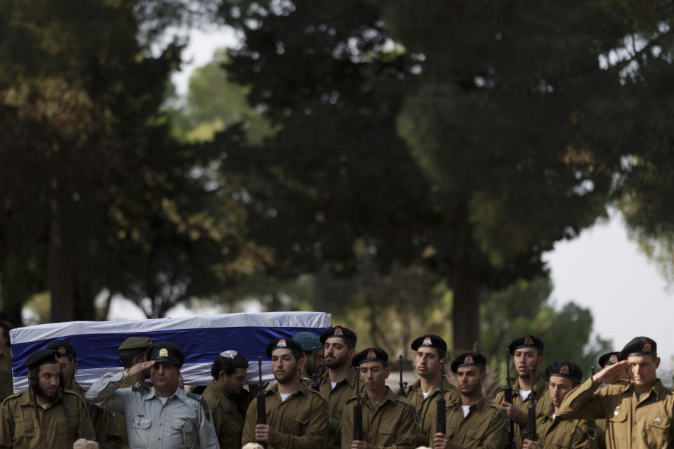 Israeli soldiers carry the coffin of the staff sergeant Elisha Yehonatan Lober, who was killed in battle in the Gaza Strip, during his funeral at the Mount Herzl military cemetery in Jerusalem, Israel, Wednesday, Dec. 27, 2023. (AP Photo/Leo Correa)