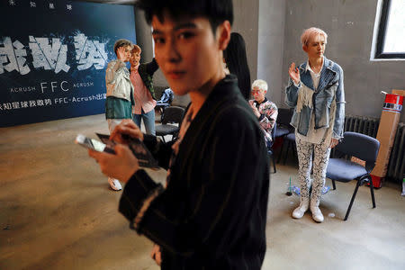 FILE PHOTO: Members of China's all-girl "boyband" FFC-Acrush wave from backstage after their maiden press conference in Beijing, China April 28, 2017. REUTERS/Damir Sagolj/File Photo