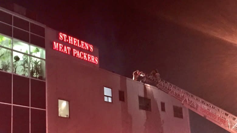 Health officials inspecting products at meat packaging plant after rooftop fire