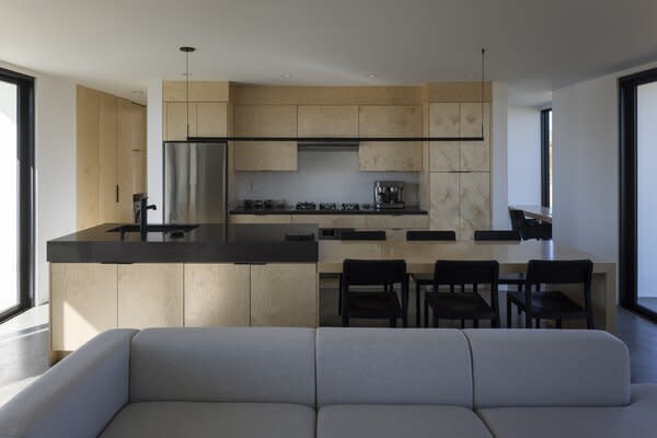 The interiors, by Francesca's Interlude Studio, feature simple maple cabinetry and concrete floors.