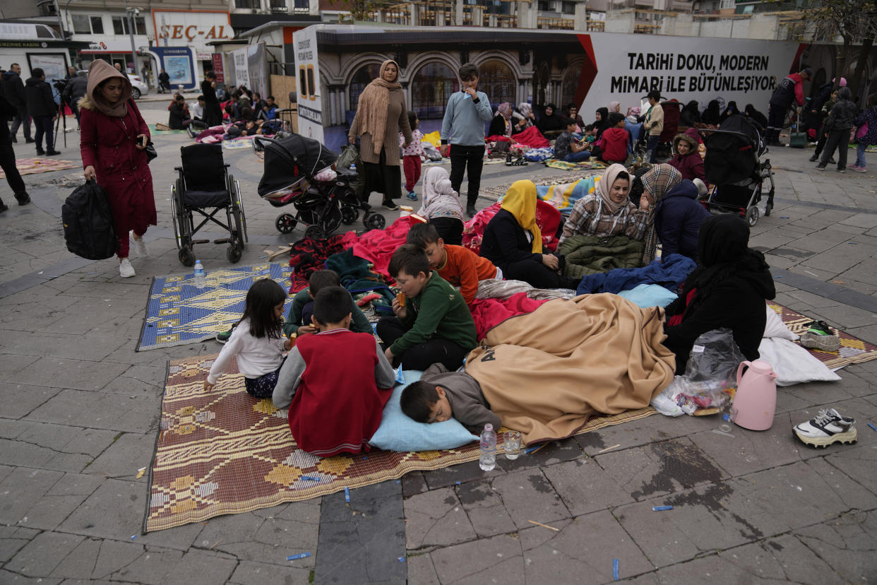 People rest outside their homes in Duzce, Turkey, Wednesday, Nov. 23, 2022, after a magnitude 5.9 earthquake hit a town in northwest Turkey early Wednesday, causing damage to some buildings and widespread panic. At least 68 people were injured, mostly while trying to flee homes. The earthquake was centered in the town of Golkaya, in Duzce province, some 200 kilometers (125 miles) east of Istanbul, the Disaster and Emergency Management Presidency said.(AP Photo/Khalil Hamra)