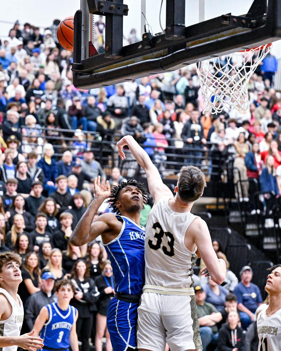 Penn's Dylan Derda (33) blocks the shot attempt by Marian’s Dareon Thornton (2) in the fourth quarter Friday, Jan. 20, 2023, at Penn High School. Penn won 66-52.