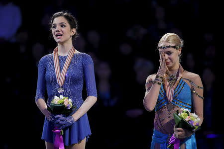 Figure Skating - ISU World Figure Skating Championships - Ladies Free Skate program - Boston, Massachusetts, United States - 02/04/16 - Gold medalist Evgenia Medvedeva of Russia (L) and bronze medalist Anna Pogorilaya of Russia react during their national anthem on the awards podium. REUTERS/Brian Snyder