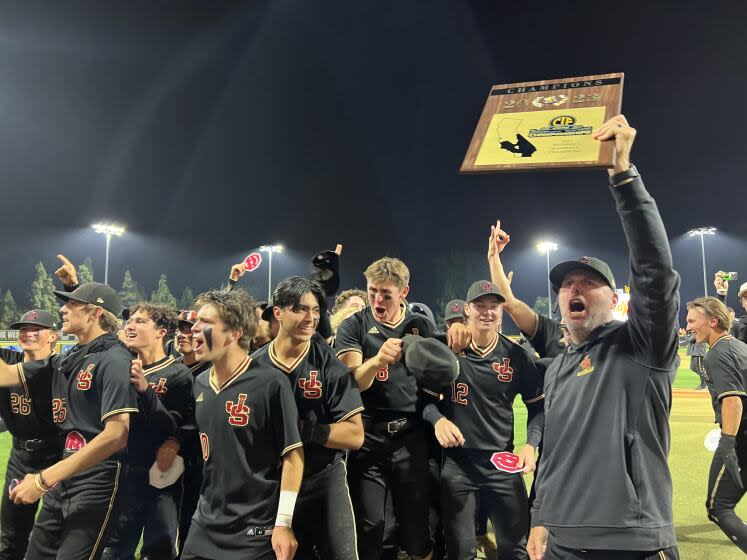 JSerra coach Brett Kay and his players celebrate a second straight Division 1 baseball title with a 1-0, eight-inning win.