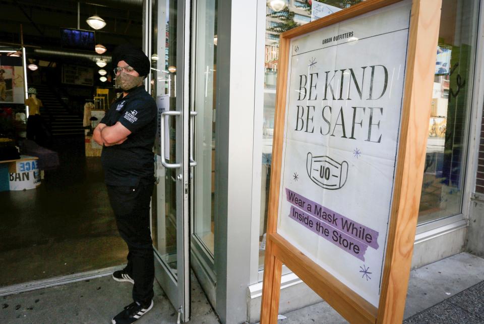 A sign is seen outside a store to remind customers to wear masks in Vancouver, British Columbia, Canada, on Aug. 25, 2021. British Columbia's public health order requiring masks in most indoor public settings came into effect Wednesday, in an effort to combat the Delta variant and a fourth wave of COVID-19. (Photo by Liang Sen/Xinhua via Getty Images)