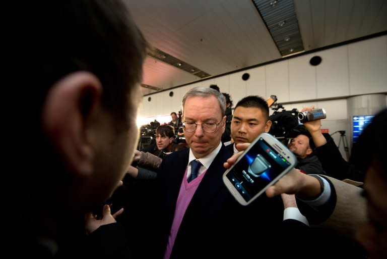 Google chairman Eric Schmidt (C) is surrounded by the media after arriving in Beijing from North Korean capital Pyongyang, on January 10, 2013. Schmidt told North Korean officials their country would never develop unless it embraced Internet freedom, he said as he returned from his trip