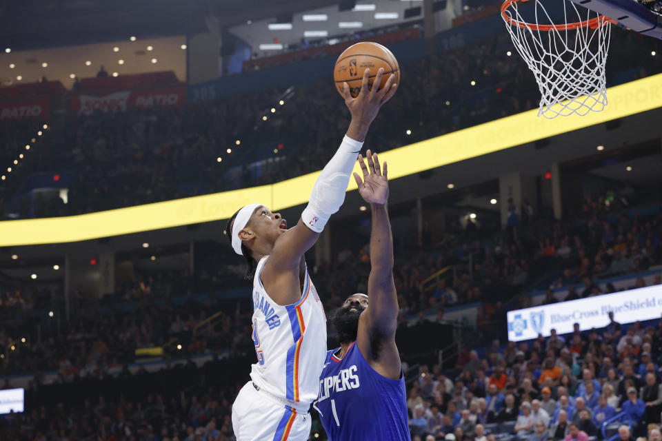 Feb 22, 2024; Oklahoma City, Oklahoma, USA; Oklahoma City Thunder guard Shai Gilgeous-Alexander (2) shoots as LA Clippers guard James Harden (1) defends during the second quarter at Paycom Center. Mandatory Credit: Alonzo Adams-USA TODAY Sports