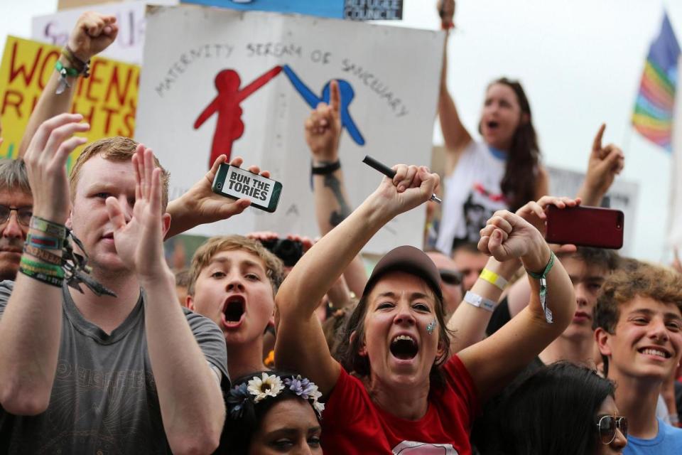 Cheers: Festival-goers react during Britain's Labour Party leader Jeremy Corbyn's speech (EPA)