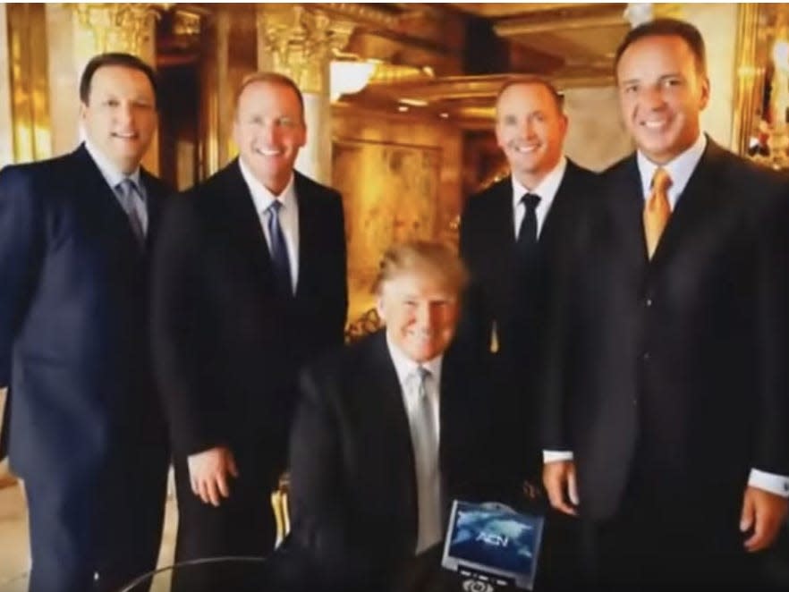 Trump with the ACN videophone and the ACN co-founders