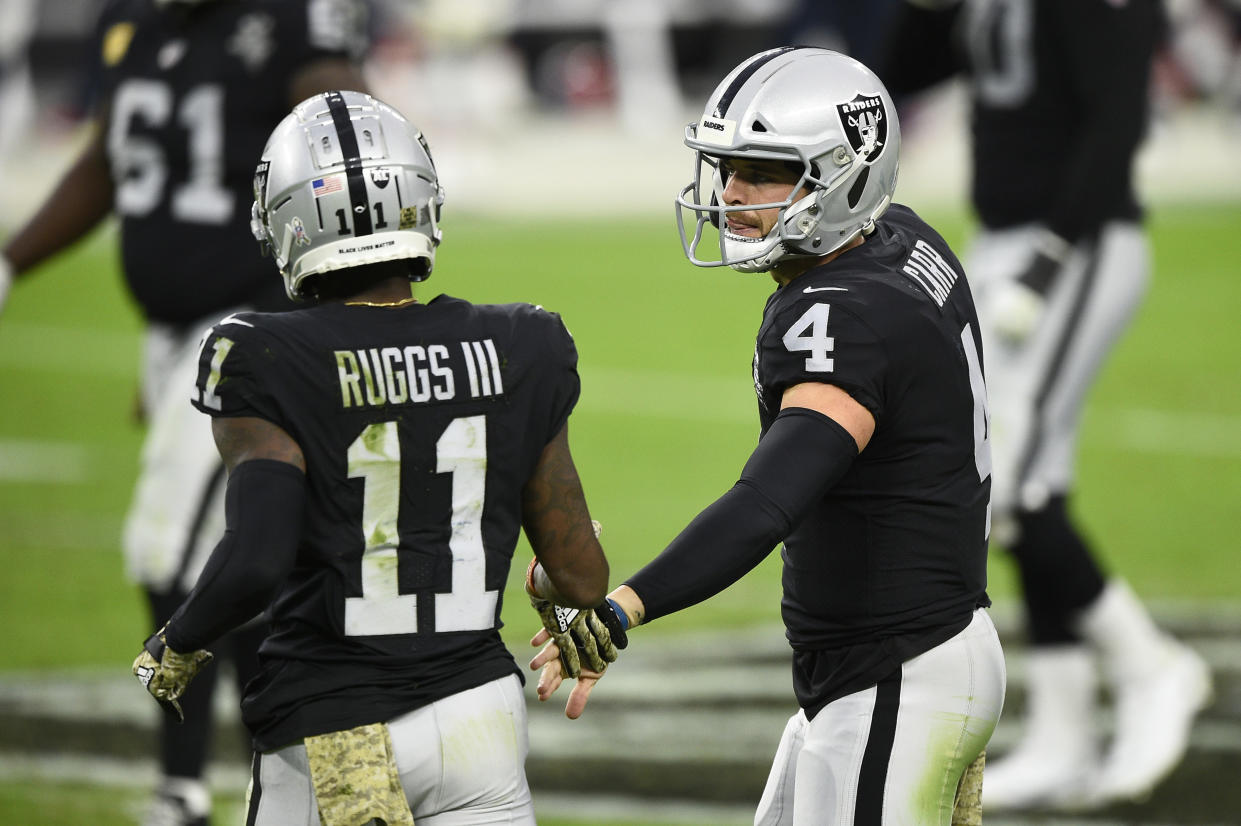 LAS VEGAS, NEVADA - NOVEMBER 15:  Quarterback Derek Carr #4 and wide receiver Henry Ruggs III #11 of the Las Vegas Raiders celebrate in the second half of their game against the Denver Broncos at Allegiant Stadium on November 15, 2020 in Las Vegas, Nevada. (Photo by Chris Unger/Getty Images)