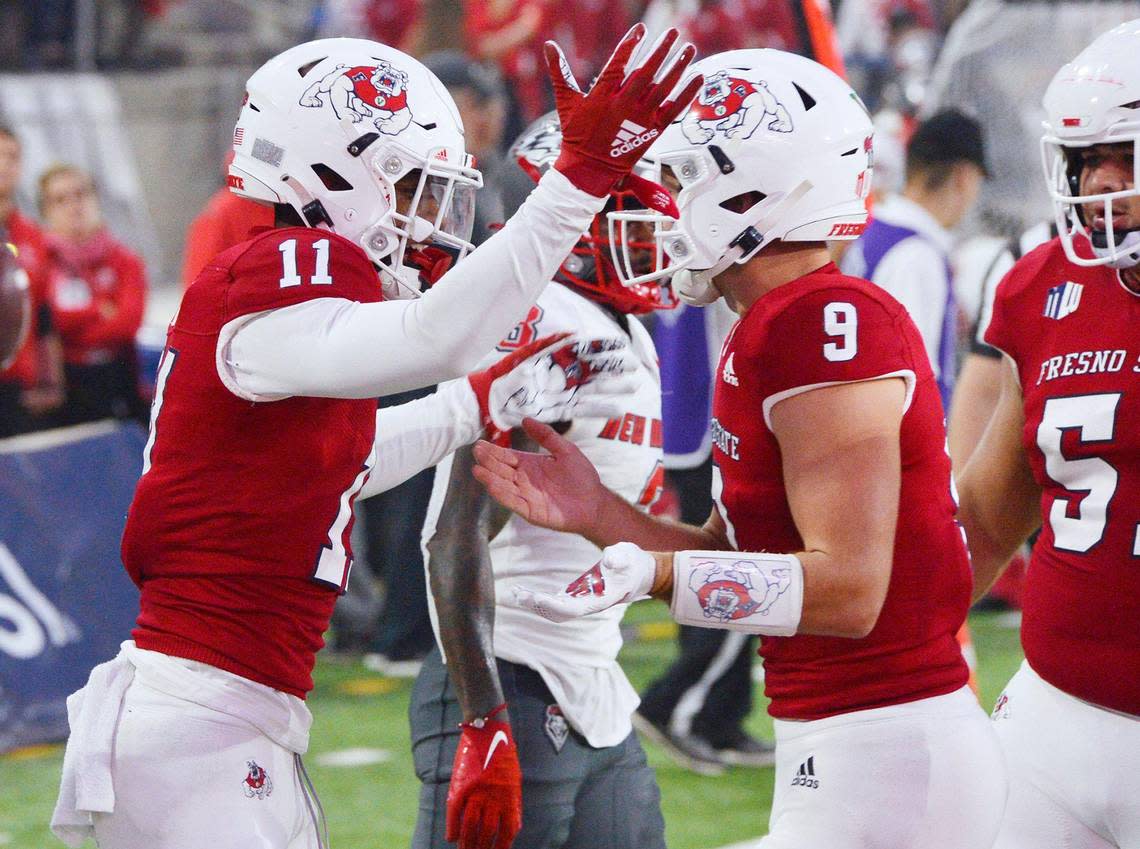 Fresno State wideout Josh Kelly, left, celebrates with quarterback Jake Haener after they teamed up on a 21-yard touchdown pass in the Bulldogs’ 34-7 victory over the New Mexico Lobos, Saturday, Nov. 13, 2021 in Fresno.