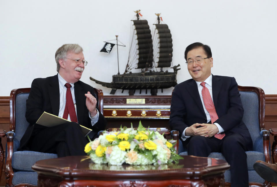 In this photo provided by South Korea Presidential Blue House via Yonhap News Agency, U.S. National Security Advisor John Bolton, left, talks with South Korean National Security Advisor Chung Eui-yong during a meeting at the presidential Blue House in Seoul, South Korea, Wednesday, July 24, 2019. (South Korea Presidential Blue House/Yonhap via AP)