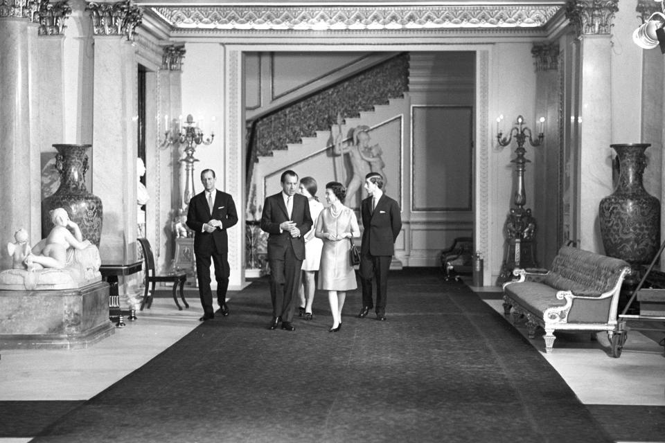 Queen Elizabeth II with American President Richard Nixon, as they walk through the corridors of Buckingham Palace on February 25, 1969. With them are the Duke of Edinburgh and Prince of Wales.