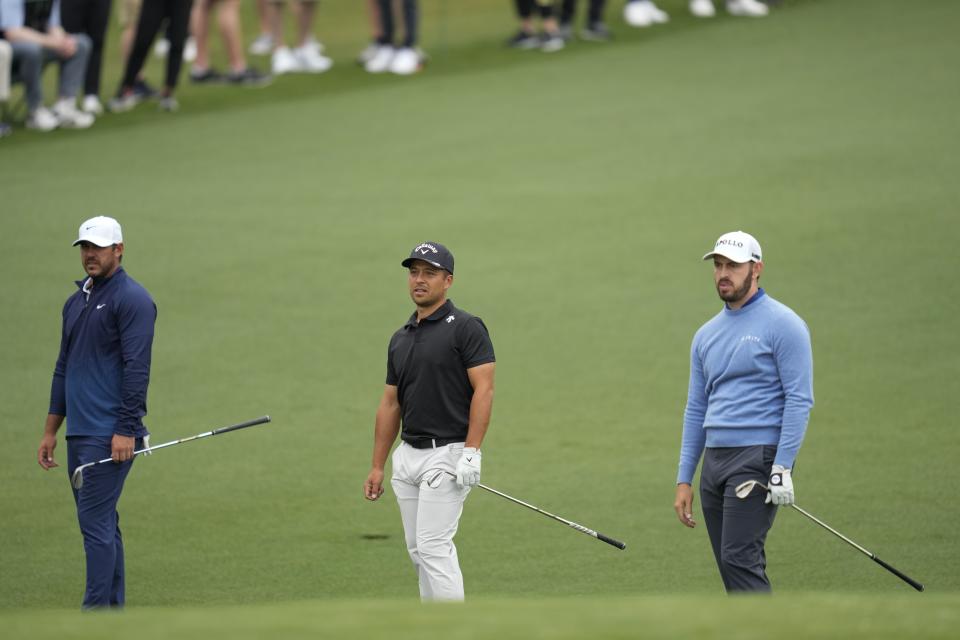 Brooks Koepka, from left, Xander Schauffele and Patrick Cantlay hits on the second hole during a practice round in preparation for the Masters golf tournament at Augusta National Golf Club Tuesday, April 9, 2024, in Augusta, Ga. (AP Photo/Ashley Landis)
