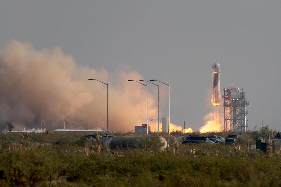 VAN HORN, TEXAS - JULY 20:  The New Shepard Blue Origin rocket lifts-off from the launch pad carrying Jeff Bezos along with his brother Mark Bezos, 18-year-old Oliver Daemen, and 82-year-old Wally Funk prepare to launch on July 20, 2021 in Van Horn, Texas. Mr. Bezos and the crew are riding in the first human spaceflight for the company.   (Photo by Joe Raedle/Getty Images)