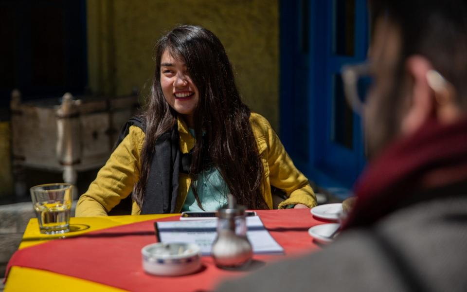 Massouma Tajik, 22, sits in a Kabul coffee shop, catching up with her friends - Stefanie Glinski 