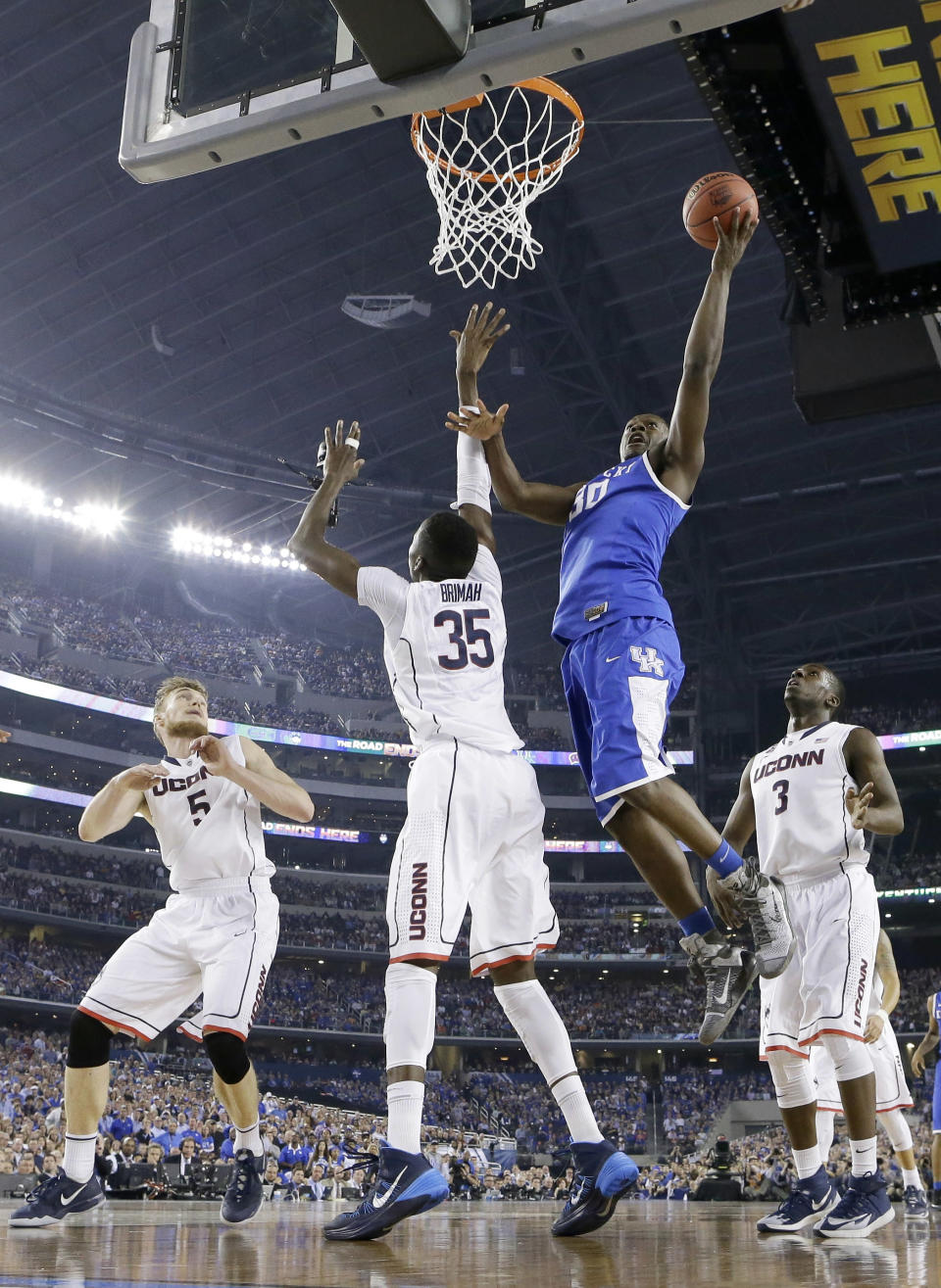 Kentucky forward Julius Randle (30) shoots over Connecticut center Amida Brimah (35) as Niels Giffey (5) and Terrence Samuel (3) look on during the first half of the NCAA Final Four tournament college basketball championship game Monday, April 7, 2014, in Arlington, Texas. (AP Photo/Eric Gay)