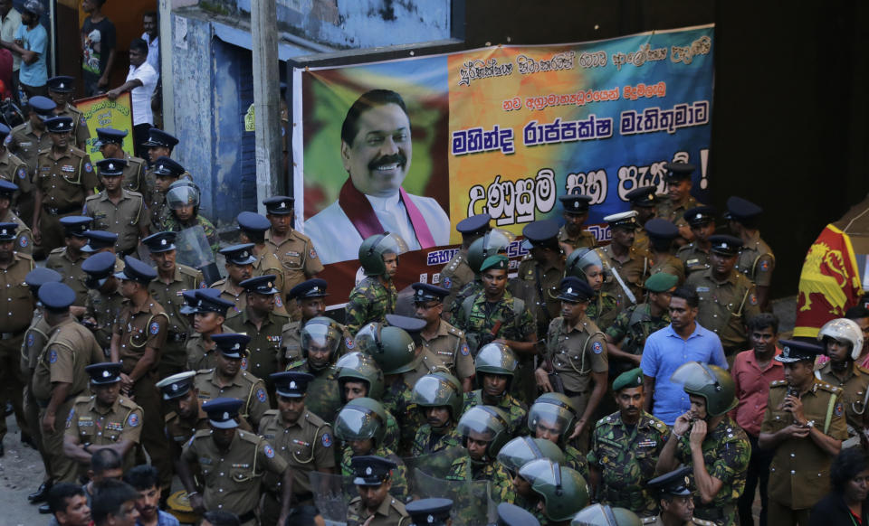 Sri Lankan security forces are deployed near the petroleum ministry building in Colombo, Sri Lanka, Sunday, Oct. 28, 2018. Arjuna Ranatunga who was petroleum minister under Wickremesinghe said one of his security guards opened fire when Rajapaksa supporters mobbed him and protested against him entering the ministry premises. (AP Photo/Eranga Jayawardena)