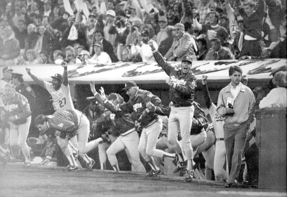 Tommy Lasorda, center, and the rest of the Dodgers run onto the field to celebrate their 1988 World Series victory.