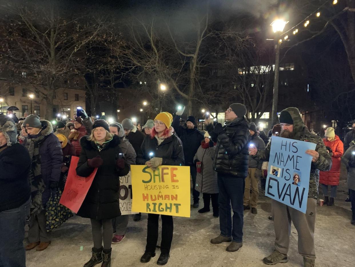 About a hundred people gathered in King's Square in Saint John for a vigil following a death at a homeless encampment in the city. (Nipun Tiwari / CBC News - image credit)