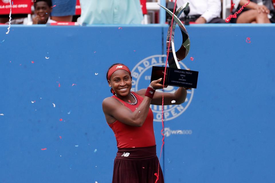 American Coco Gauff celebrates with the Donald Dell championship trophy after beating Maria Sakkari in the women's singles final of the Mubadala Citi DC Open in Washington.