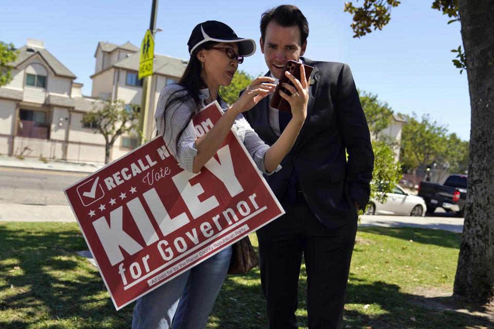 Assemblyman Kevin Kiley, right, of Rocklin, a Republican candidate for governor in the Sept. 14 recall election, speaks with supporter Nancy Jiang during a campaign stop outside of Manual Arts High School, Monday, Sept. 13, 2021, in Los Angeles. (AP Photo/Marcio Jose Sanchez)