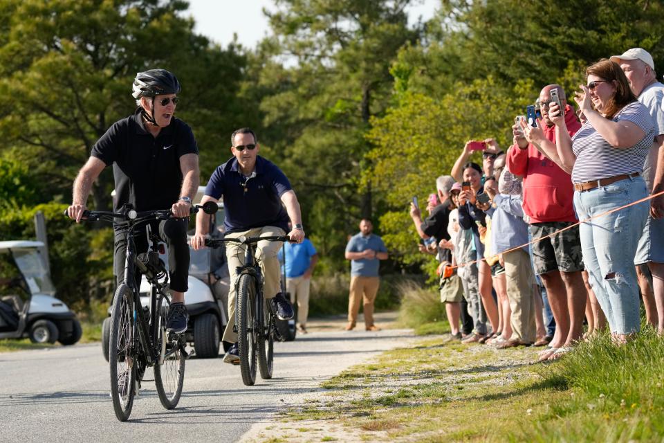 Joe Biden rides his bike past crowds in Rehoboth Beach, Delaware.