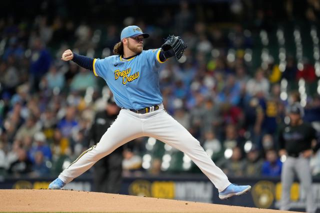 Corbin Burnes and Willy Adames of the Milwaukee Brewers receive
