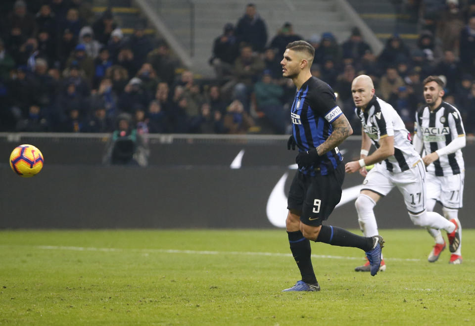 Inter Milan's Mauro Icardi scores his team's first goal on a penalty kick during an Italian Serie A soccer match between Inter Milan and Udinese, at the San Siro stadium in Milan, Italy, Saturday, Dec. 15, 2018. (AP Photo/Antonio Calanni)