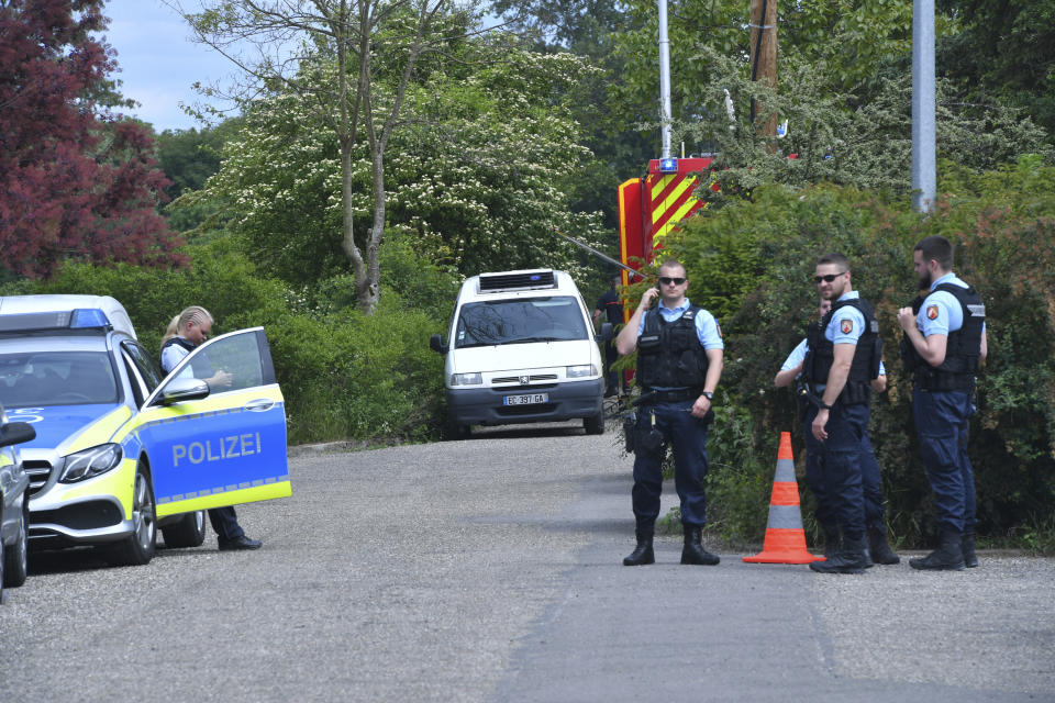 German police officers wait near Gerstheim, eastern France, Thursday, May 30, 2019. Police say three people were killed and a child disappeared after a small boat capsized in the Rhine River between Germany and France. (AP Photo)