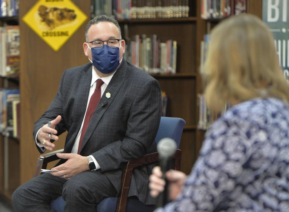 U.S. Education Secretary Miguel Cardona talks with Fort LeBoeuf Middle School teacher Laura Friedman about safely returning to schools on March 3, 2021, in Waterford, Pa., during a visit with first lady Jill Biden.