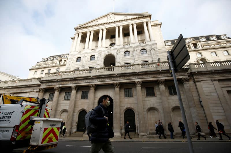 A man wearing a protective face mask, following an outbreak of the coronavirus, walks in front of the Bank of England in London