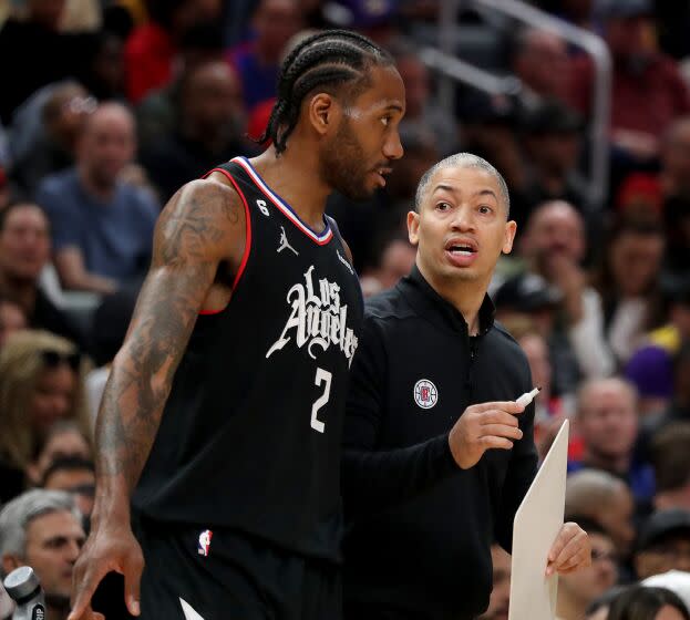 Los Angeles, CA - April 05: Clippers forward Kawhi Leonard tal;ks with coach Tyronn Lue.