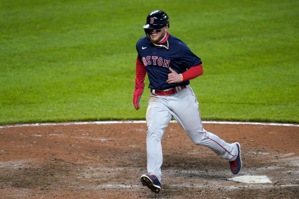 Boston Red Sox's Alex Verdugo scores on a single by Christian Vazquez during the tenth inning of a baseball game against the Baltimore Orioles, Saturday, April 10, 2021, in Baltimore. The Red Sox won 6-4 in ten innings. (AP Photo/Julio Cortez)