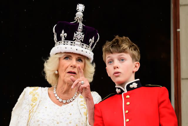 <p>LEON NEAL/POOL/AFP via Getty</p> Queen Camilla talks to her grandson Freddy Parker Bowles on the Buckingham Palace balcony following the coronation ceremony on May 6, 2023.