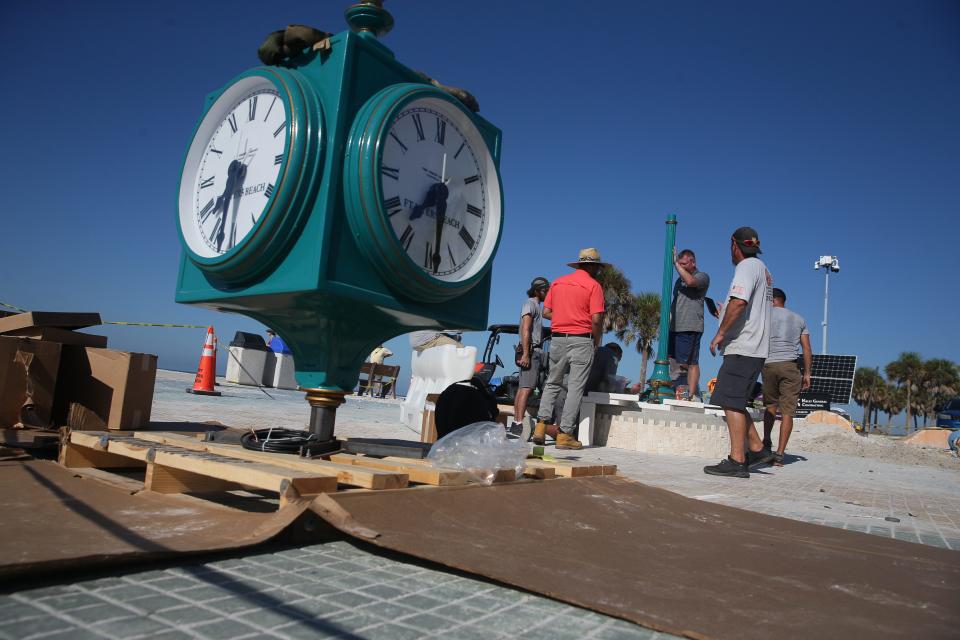 Crews with the Verdin Company and Kell]y General Contracting install the new clock in Times Square on Fort Myers Beach on Thursday, Sept. 14, 2023.  The original clock was destroyed after Hurricane Ian decimated the island on Sept. 28, 2022 . The clock will be covered until it is unveiled during a ceremony on Sept. 28, 2023. 