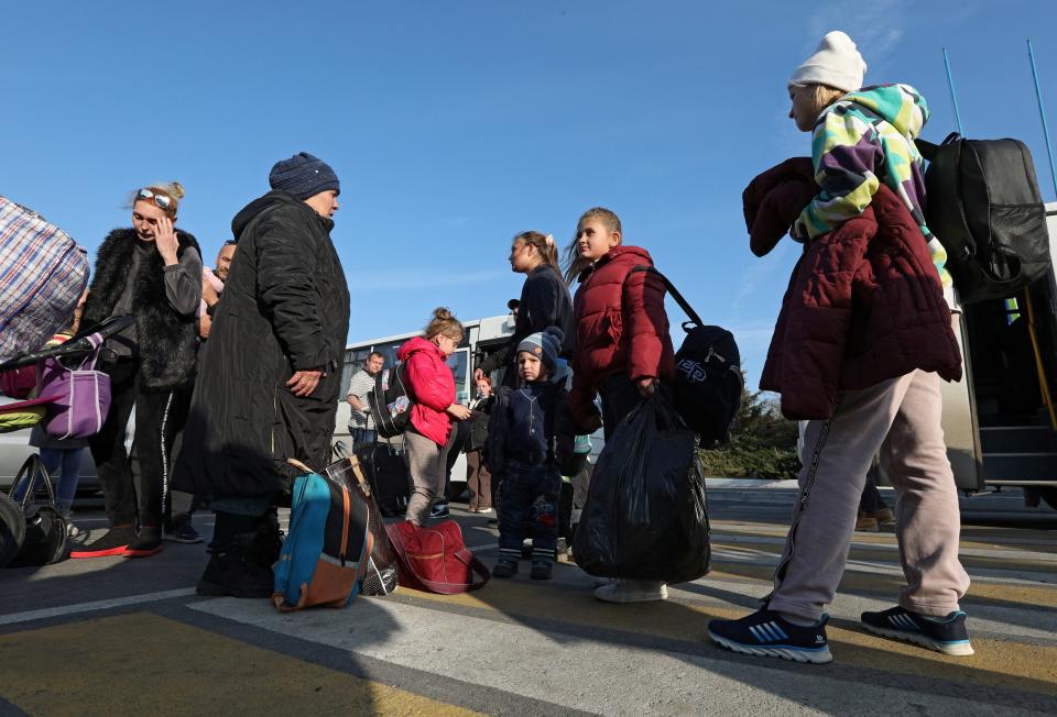 Civilians evacuated from Kherson arrive at a local railway station in the town of Dzhankoi, Crimea (Reuters)