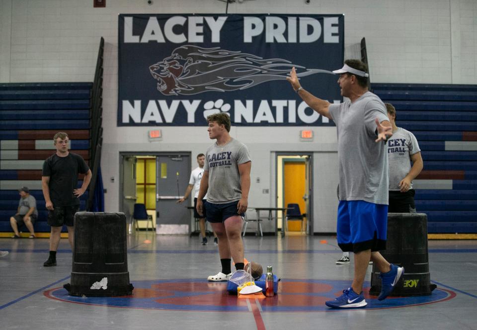 Lacey Township High School football team members go through drills during a practice session in the gym.   Lanoka Harbor, NJTuesday, July 5, 2022