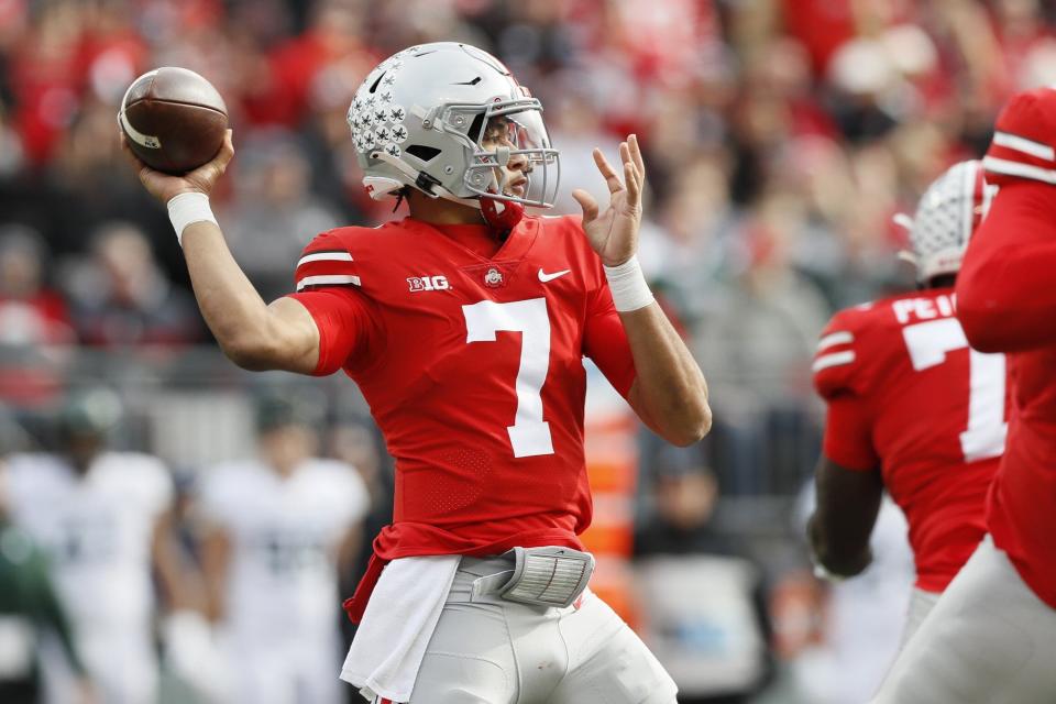 Ohio State Buckeyes quarterback C.J. Stroud (7) throws a touchdown pass to wide receiver Garrett Wilson during the first quarter of the NCAA football game against the Michigan State Spartans at Ohio Stadium in Columbus on Saturday, Nov. 20, 2021. 