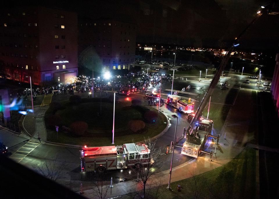 Individuals from the community in combination with emergency responders gather outside the pediatric unit at Corewell Health William Beaumont University Hospital, formerly Beaumont Hospital, Royal Oak  to shine their light up to the pediatric unit as part of annual Moonbeams for Sweet Dreams campaign.