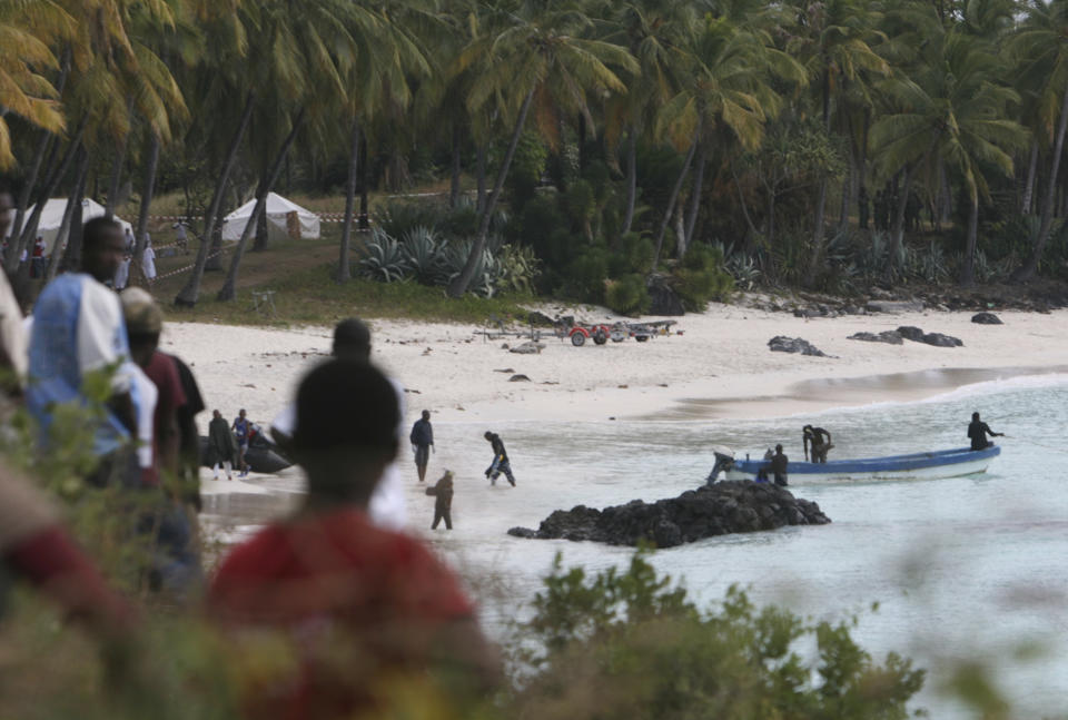 FILE - Rescuers gather at Galawa Beach, 35 kilometers from Moroni, Comoros, July 1, 2009, as they prepare to search the area after a Yemenia Airbus passenger plane crashed into the Indian Ocean off the island nation of Comoros, early Tuesday, as it attempted to land in the dark amid howling winds. The lone survivor of a 2009 plane crash that killed 152 other people is expected to attend the trial of Yemen's main airline which is opening Monday May 9, 2022 in Paris. (AP Photo/Sayyid Azim, File)