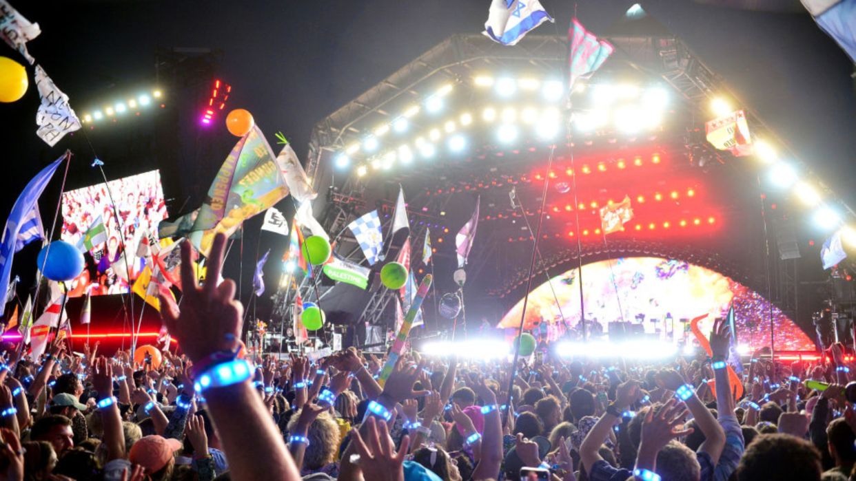  A huge crowd dances at the Pyramid Stage as Coldplay perform. 