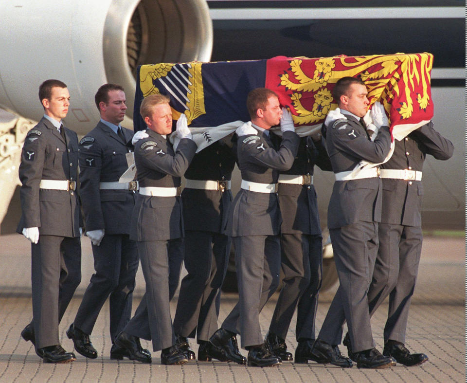 FILE - The coffin containing the body of Diana, Princess of Wales, draped with the Royal Standard, is carried by airmen of the Royal Air Force, after arriving at Northolt air base, Aug. 31, 1997 from Paris. The Princess, her companion Dodi Fayed and their driver were killed in a vehicle accident in Paris earlier in the day. The story of Princess Diana's death at age 36 in that catastrophic crash in a Paris traffic tunnel continues to shock, even a quarter-century later. (AP Photo/Alastair Grant, File)