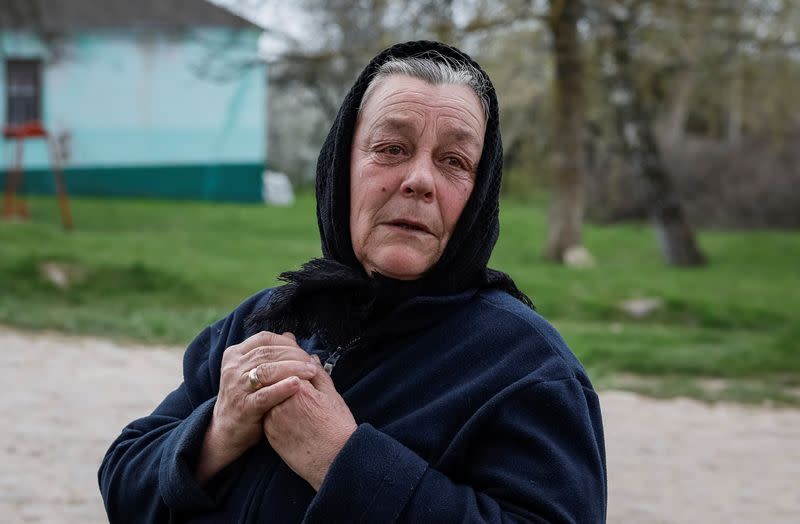 An opponent of her village's church switch from the Ukrainian Orthodox Church to the Orthodox Church of Ukraine cries while she argues with a supporter of this switch in the village of Karyshkiv