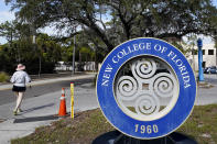 A student makes her way past the sign at New College Friday, Jan. 20, 2023, in Sarasota, Fla. Your education. Your way. Be original. Be you. That's how New College of Florida describes its approach to higher education in an admission brochure. The state school of fewer than 1,000 students nestled along Sarasota Bay has long been known for its progressive thought and creative course offerings that don't use traditional grades. The school founded in 1960 is also a haven for marginalized students, especially from the LBGTQ community, said second-year student Sam Sharf in a recent interview. (AP Photo/Chris O'Meara)