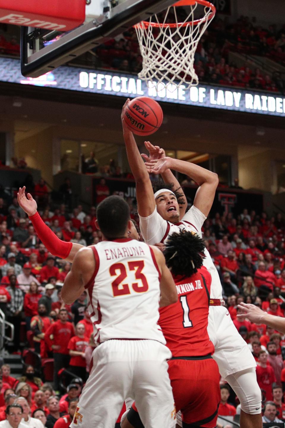 Iowa State's Robert Jones (12) goes to the basket over Texas Tech's Terrence Shannon Jr. (1) in the first half of Tuesday's game at Lubbock.