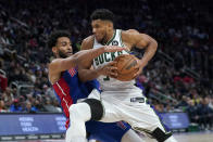 Milwaukee Bucks forward Giannis Antetokounmpo (34) drives on Detroit Pistons'Braxton Key in the first half of an NBA basketball game in Detroit, Friday, April 8, 2022. (AP Photo/Paul Sancya)