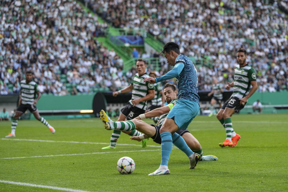 Tottenham's Son Heung-min is tailed by Sporting's Sebastian Coates during a Champions League group D soccer match between Sporting CP and Tottenham Hotspur at the Alvalade stadium in Lisbon, Tuesday, Sept. 13, 2022. (AP Photo/Armando Franca)