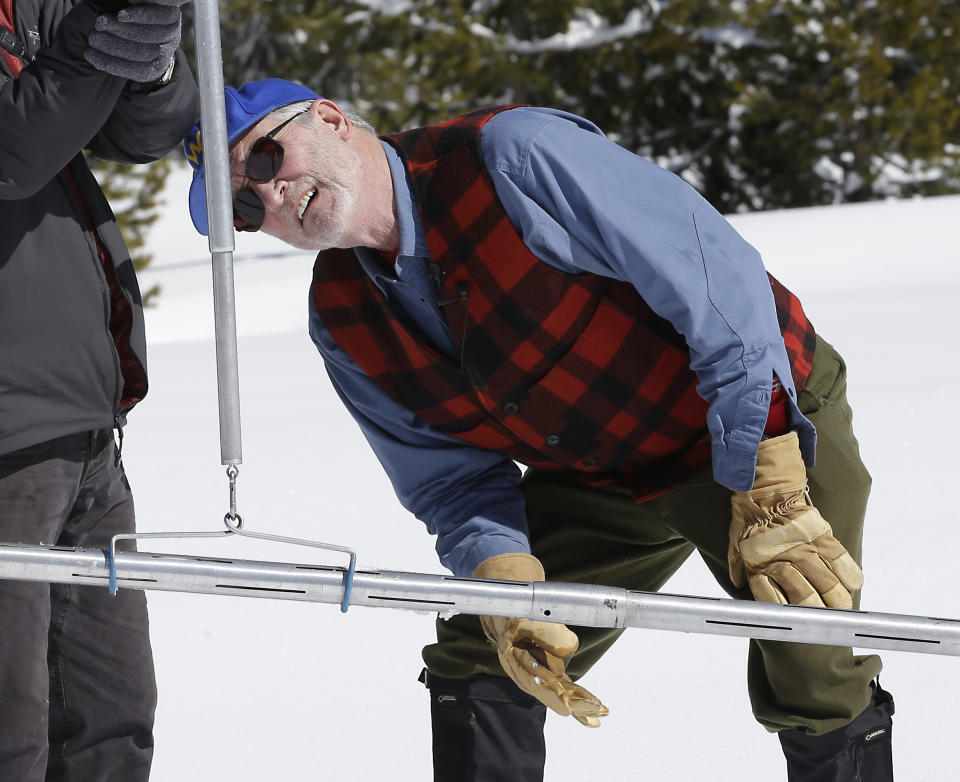 Frank Gehrke, right, chief of the California Cooperative Snow Surveys Program for the Department of Water Resources, checks the weight of the snowpack on a scale held by Armando Quintero, chairman of the California Water Commission during the third manual snow survey of the season at Phillips Station, Wednesday, March 1, 2017, near Echo Summit, Calif. The survey showed the snowpack at 179 percent of normal for this location at this time of year.The state's electronic snow monitors say the Sierra Nevada snowpack is at 185 percent of normal. (AP Photo/Rich Pedroncelli)